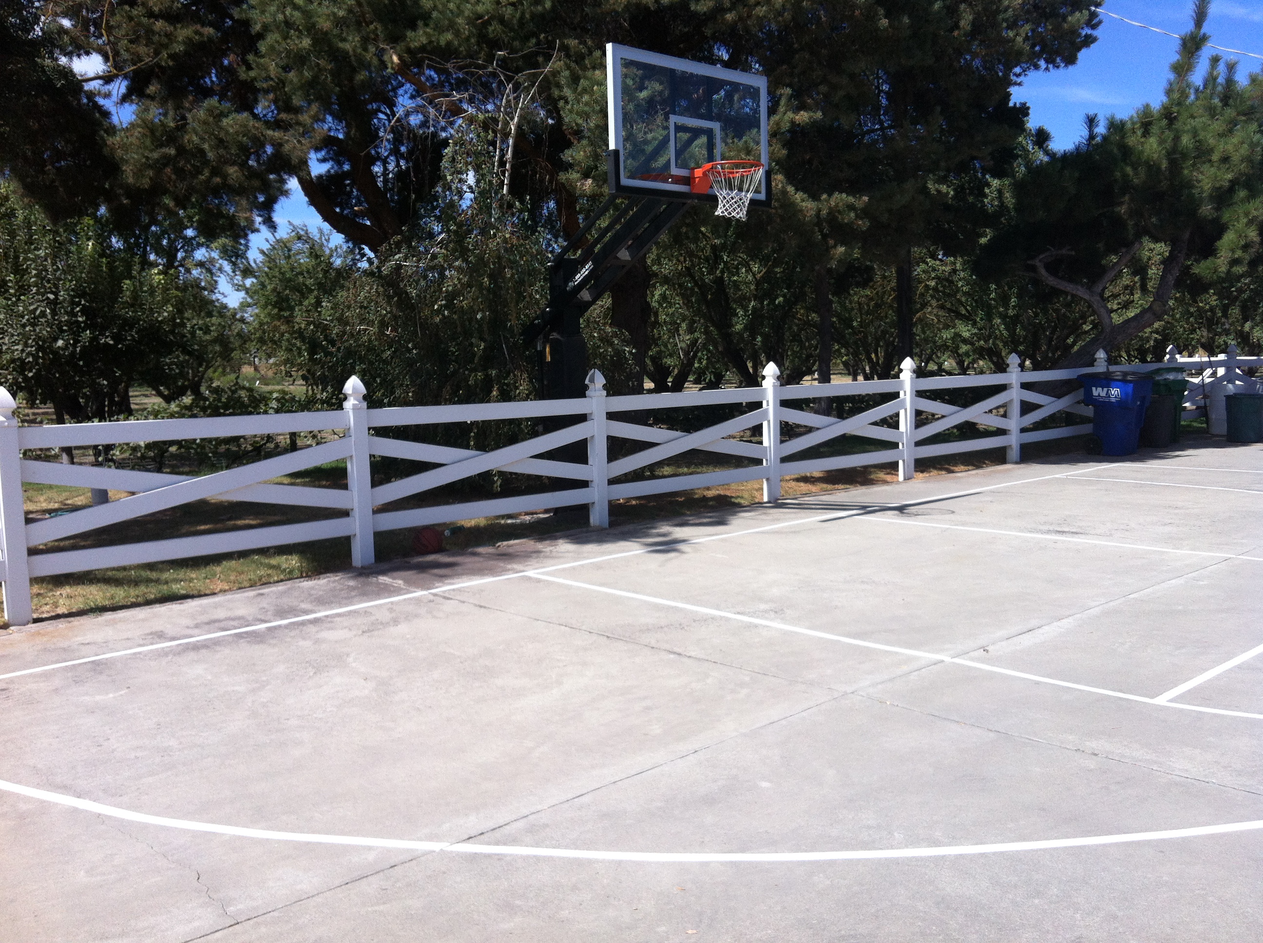 There's the hoop installed right behind the white fence.
