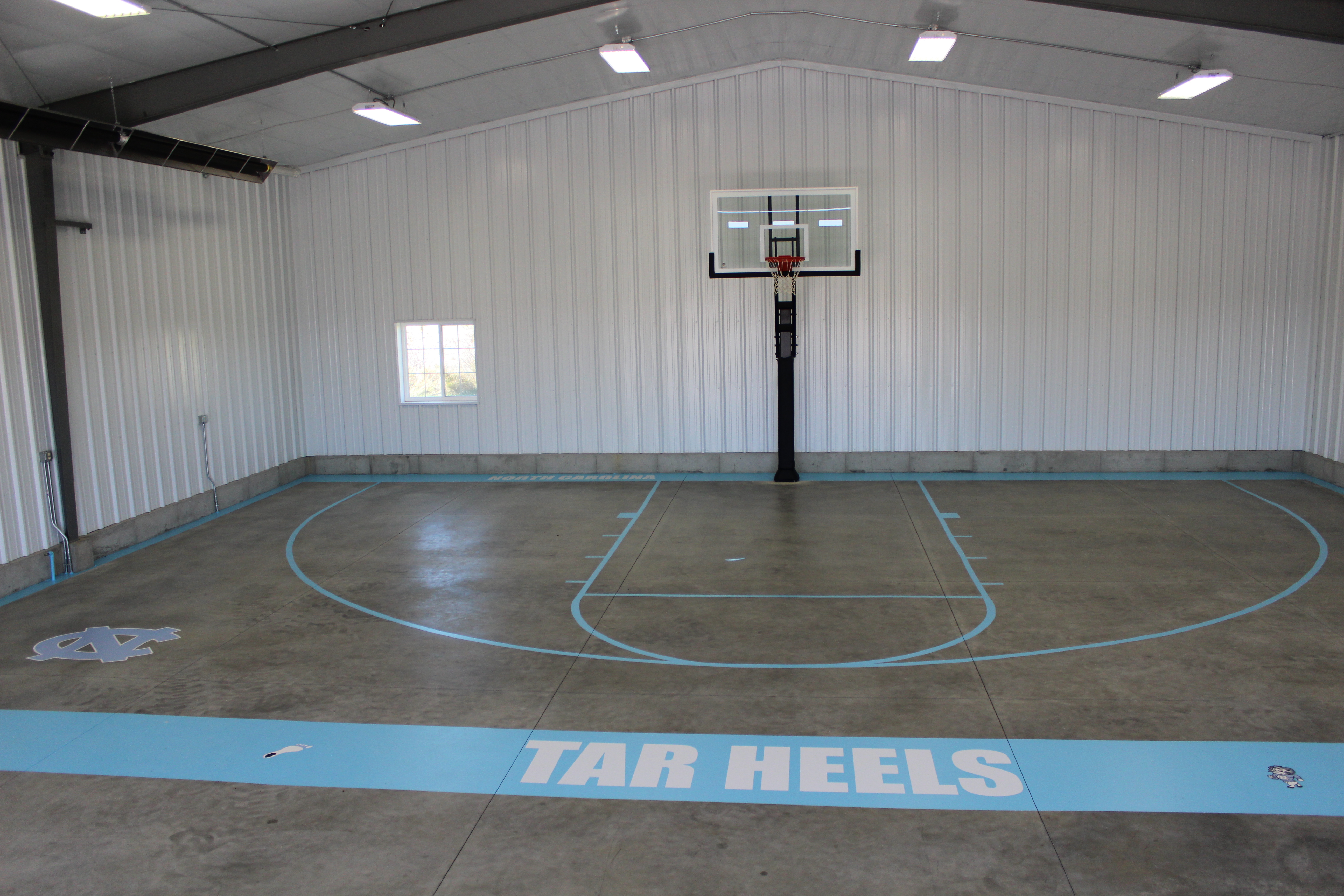This Pro Dunk Platinum Basketball System Sits In An Indoor Gym On