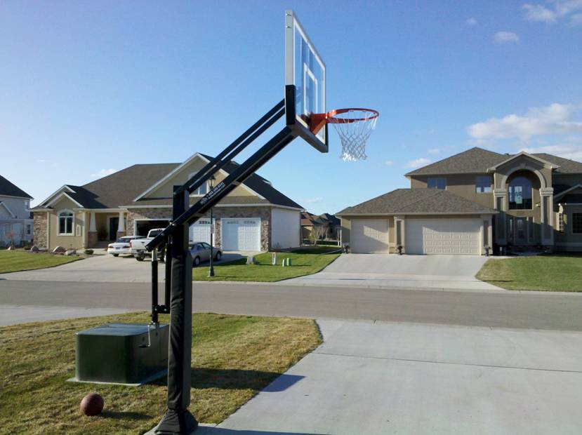 A side view of the Pro Dunk Gold basketball hoop in a seemingly common install right off the