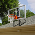 Competitive young child goes in for a layup on a lowered goal